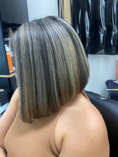 Woman with highlighted bob hairstyle in salon