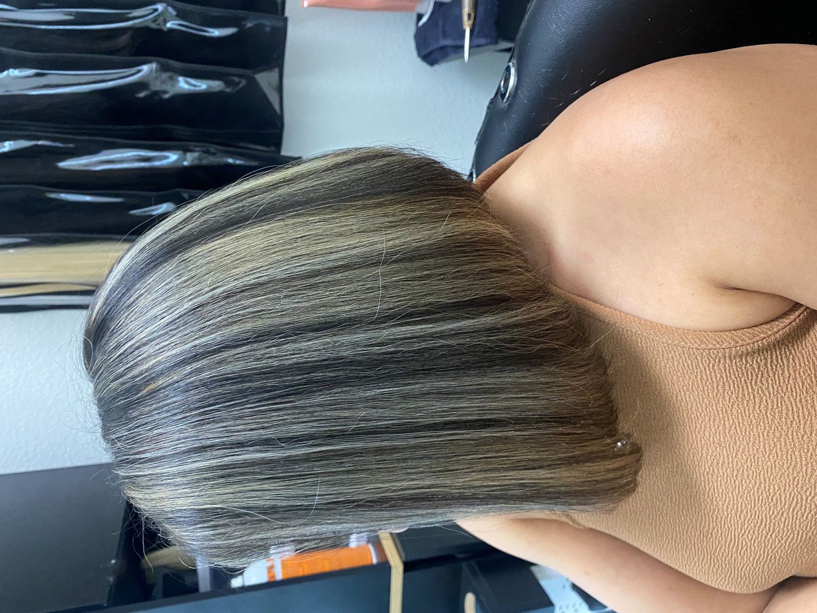 Woman with highlighted bob hairstyle in salon